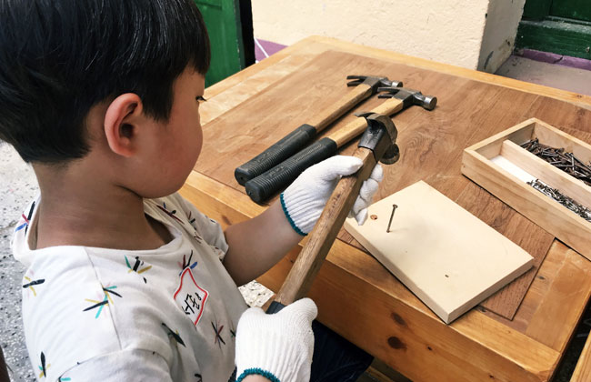 아이가 망치고 못을 박는 모습